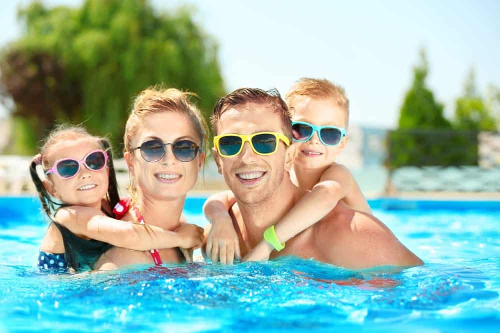 A family enjoying an inground swimming pool