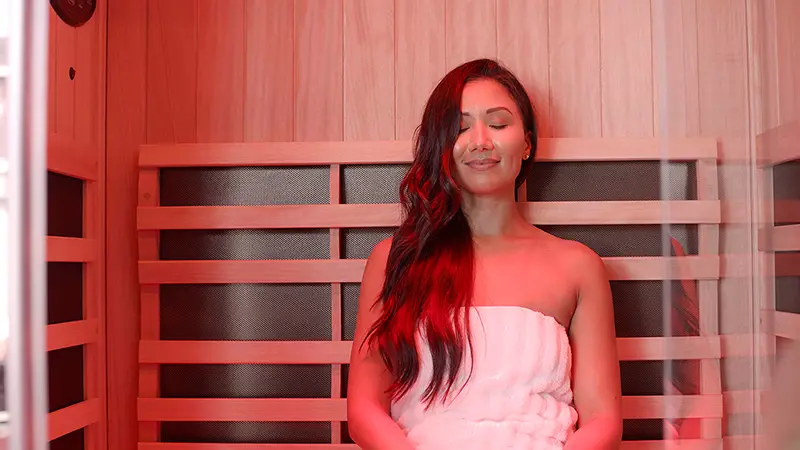 Interior shot of a woman enjoying a Jacuzzi infrared and red light therapy sauna